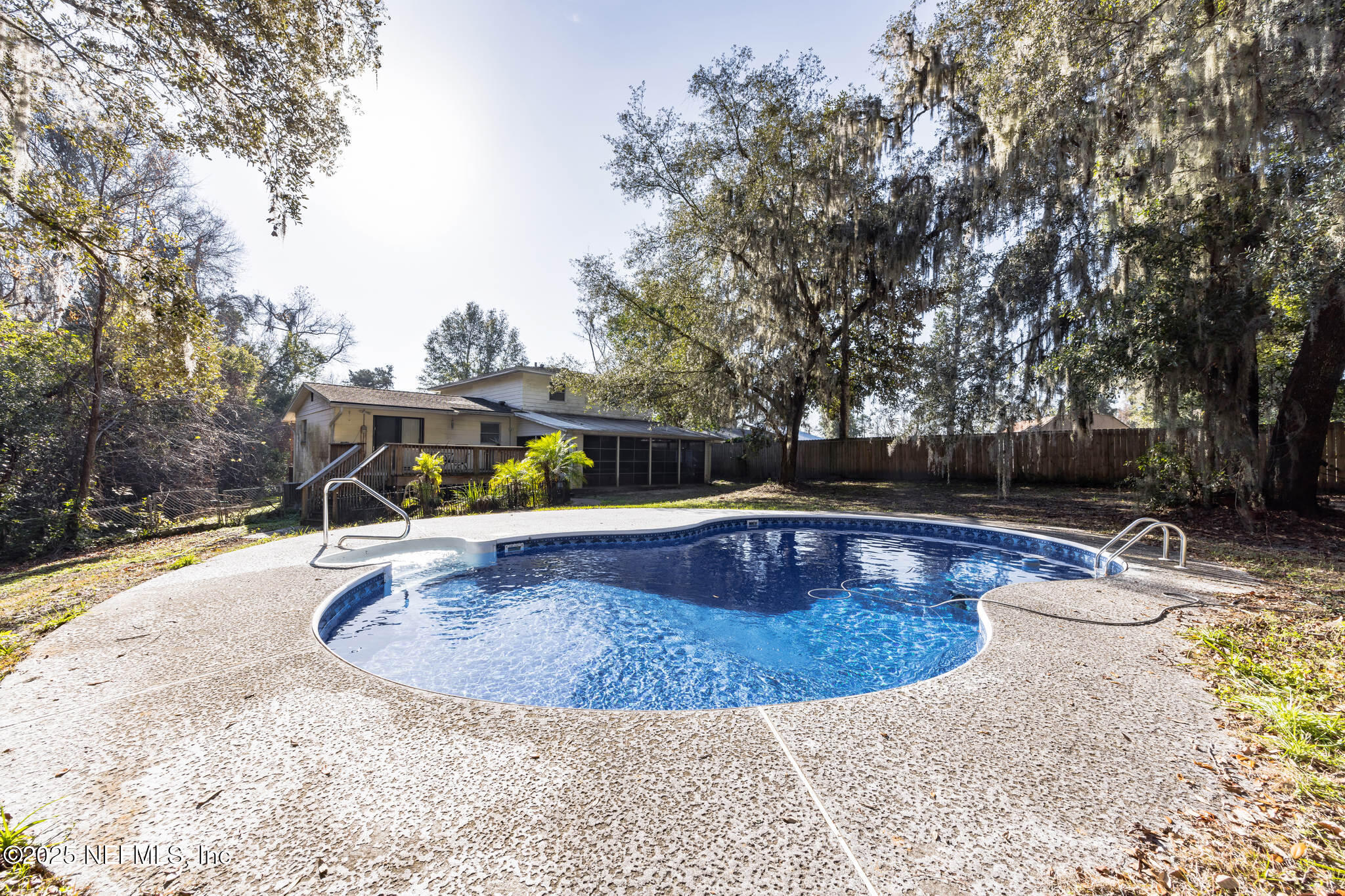 4134 Pine Road Orange Park, FL 32065 - Photo 25 of 30 a view of a swimming pool with a patio