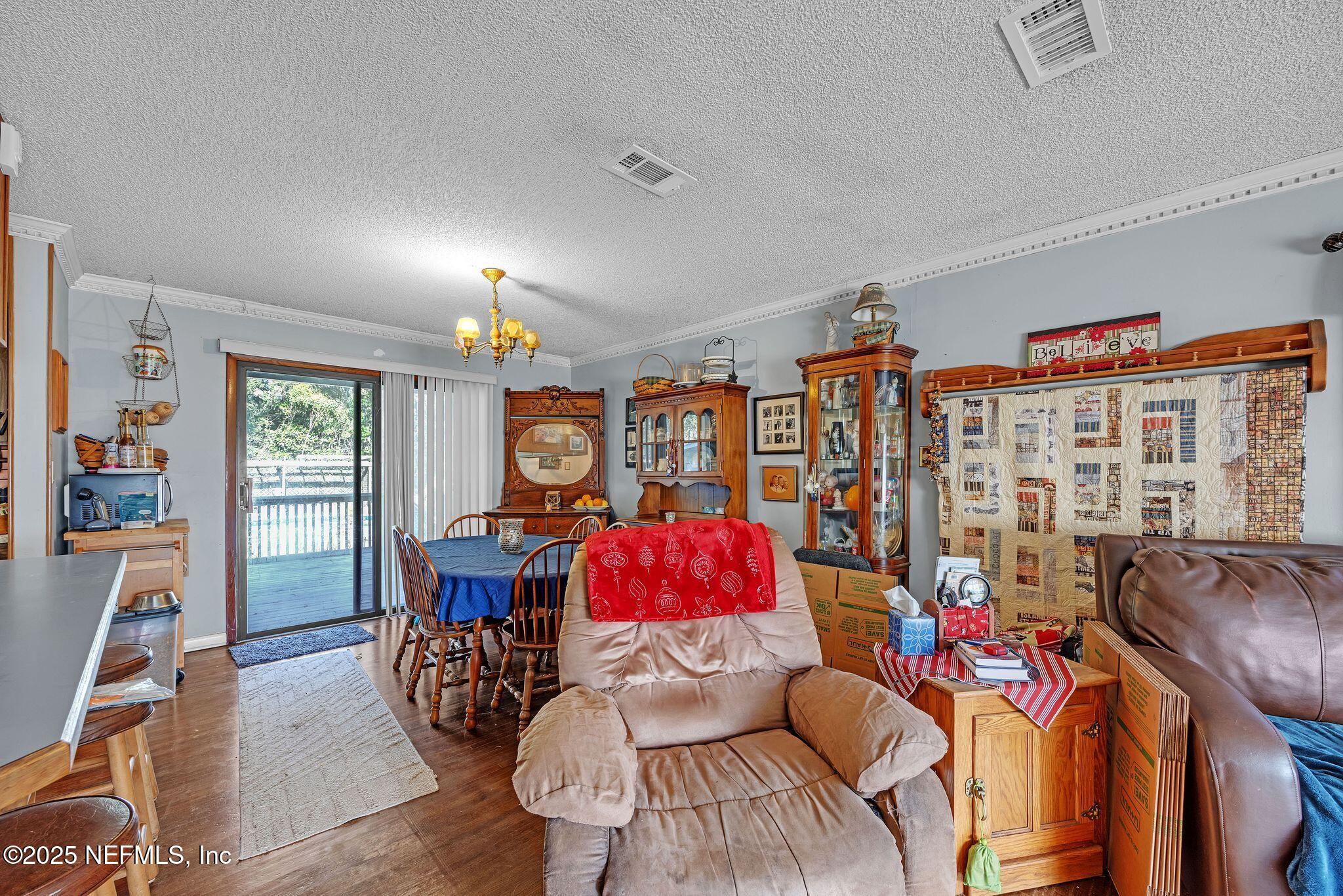 4134 Pine Road Orange Park, FL 32065 - Photo 3 of 30 a view of a dining room with furniture window and wooden floor