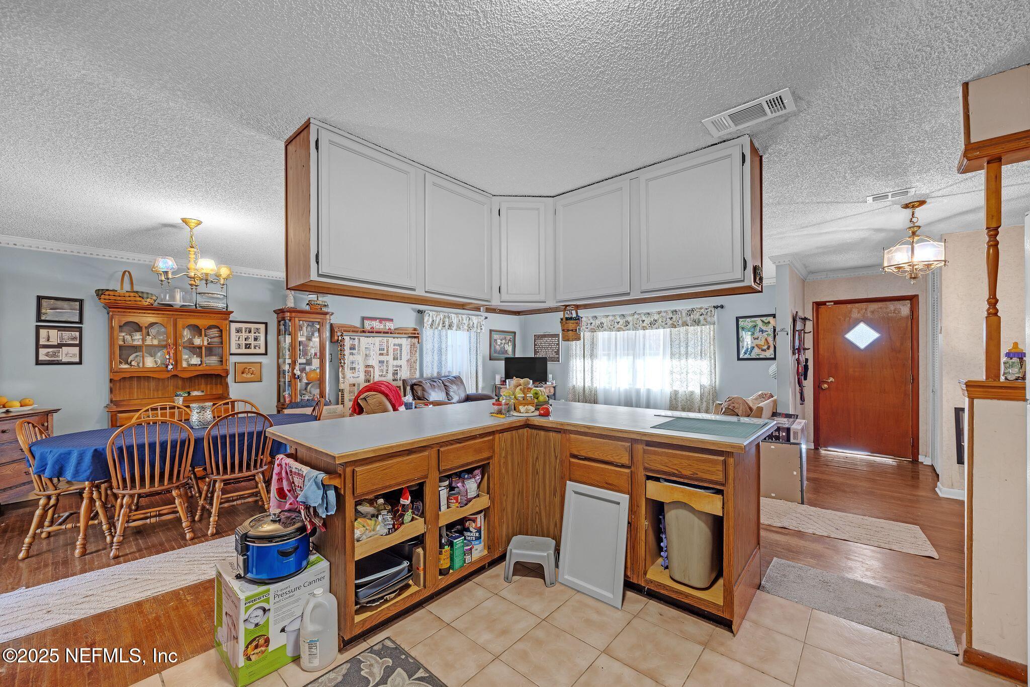 4134 Pine Road Orange Park, FL 32065 - Photo 7 of 30 a kitchen with stainless steel appliances granite countertop a sink and cabinets