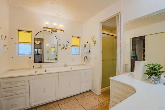 a bathroom with a double vanity sink and mirror