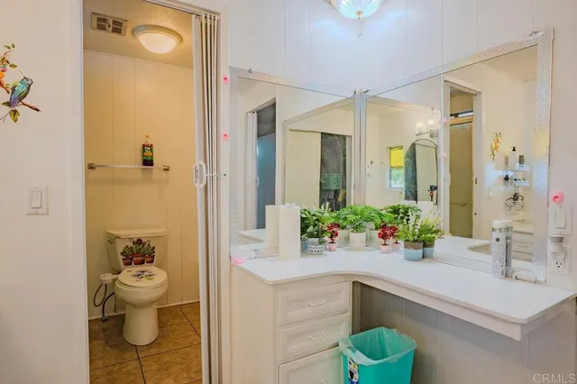 a bathroom with a sink mirror and toilet