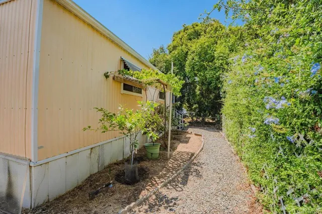 a pathway of a house with a yard