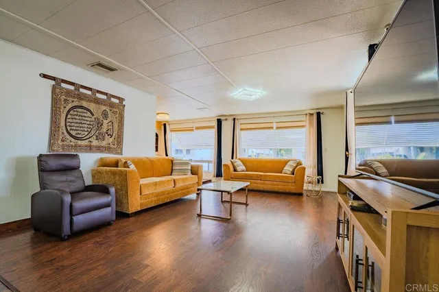 a bedroom with furniture and a large window