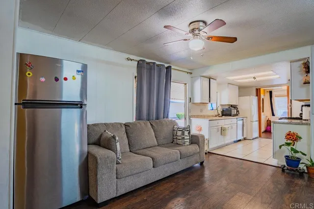 a living room with furniture and a ceiling fan
