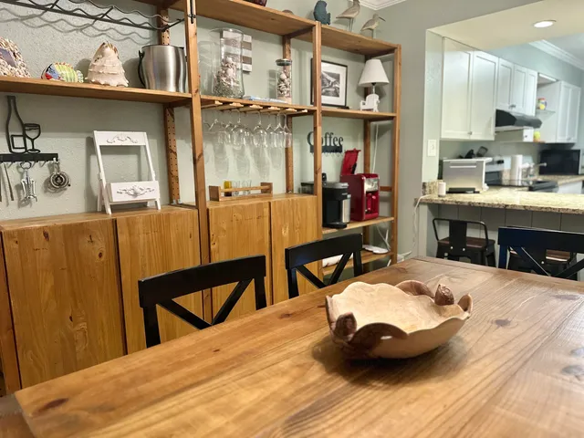 a room with table chairs and wooden floor