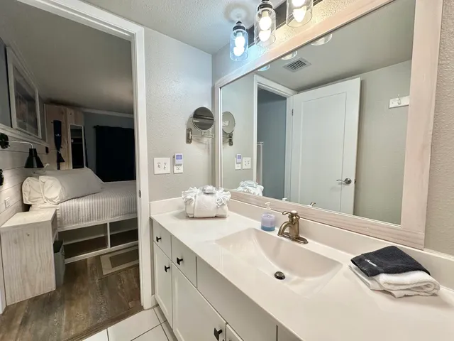 a bathroom with a double vanity sink and a mirror