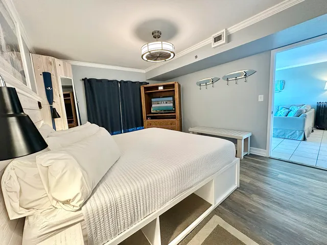 a bed sitting in a bedroom and wooden floor