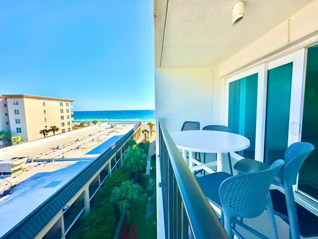 a view of a balcony dining table and chairs
