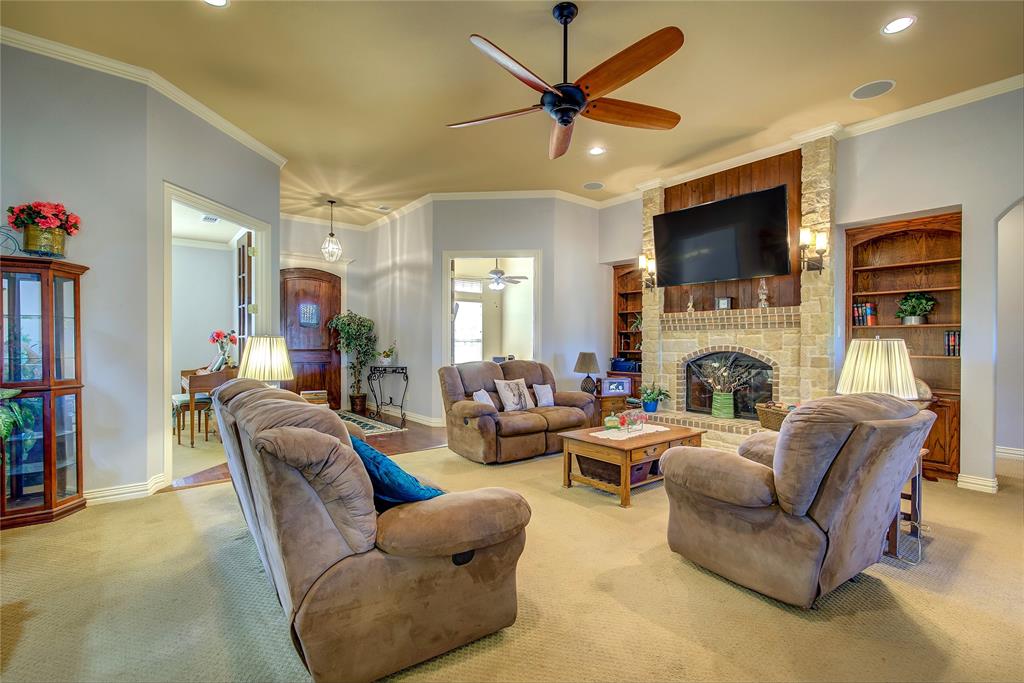 1066 Canyon Lake Road Wills Point, TX 75169 - Photo 4 of 40 a living room with furniture a flat screen tv and a fireplace