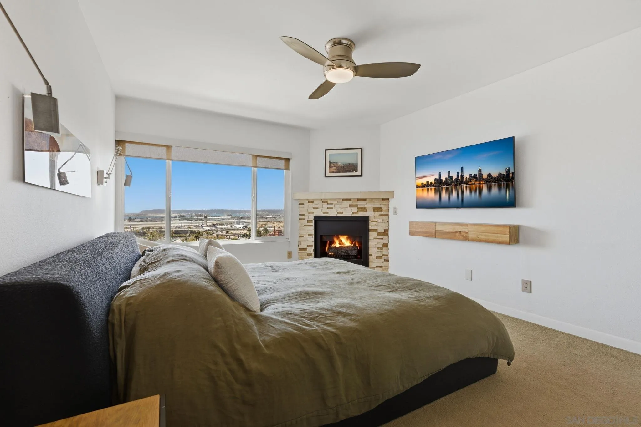 1663 Guy Street San Diego, CA 92103 - Photo 16 of 30 a spacious bedroom with a bed and a ceiling fan