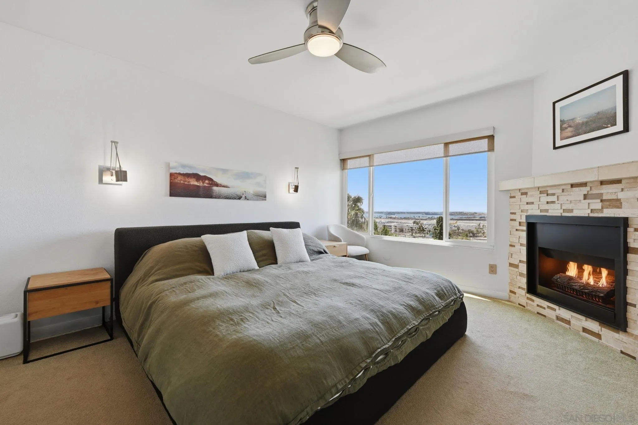 1663 Guy Street San Diego, CA 92103 - Photo 17 of 30 a spacious bedroom with a bed and a fireplace