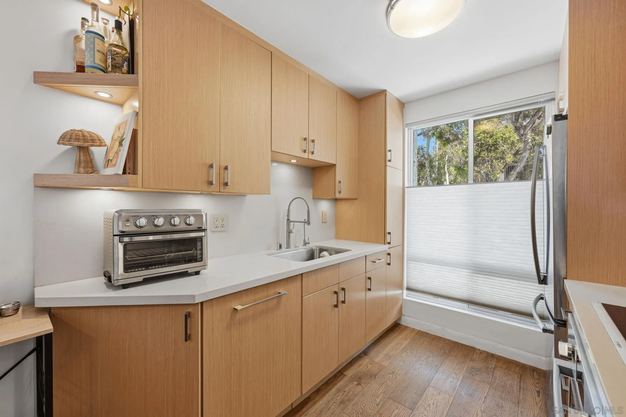 1663 Guy Street San Diego, CA 92103 - Photo 3 of 30 a kitchen with a sink a stove and cabinets