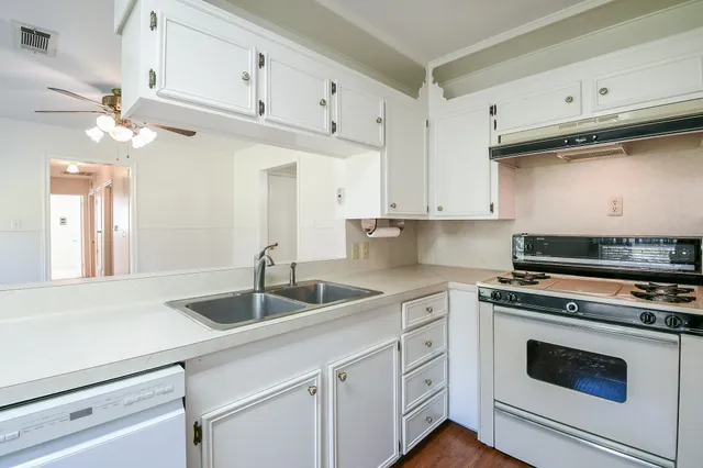 a kitchen with a stove a sink and a refrigerator
