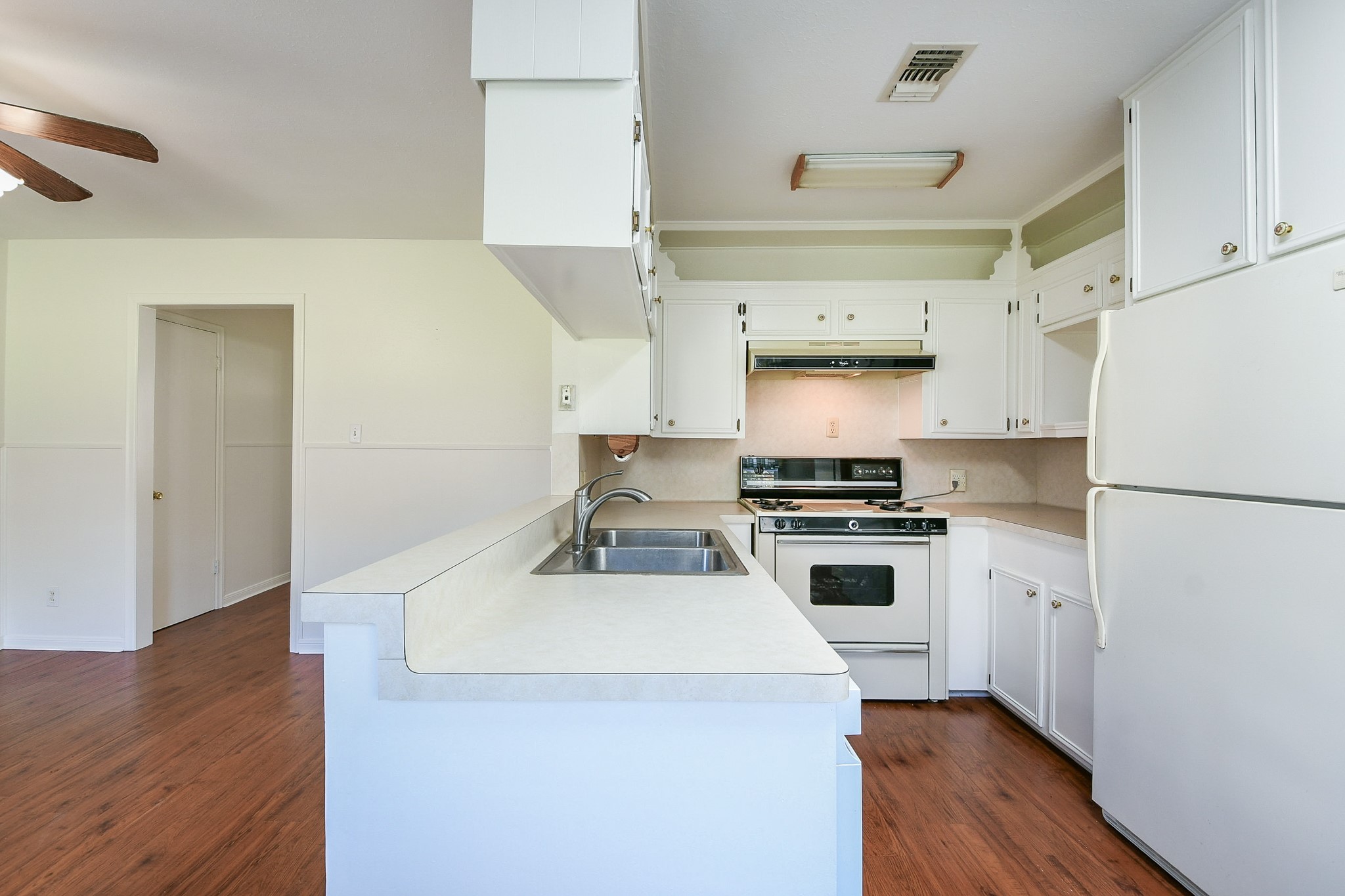 129 Cannon Street Clute, TX 77531 - Photo 14 of 28 a kitchen with a stove a sink and a refrigerator