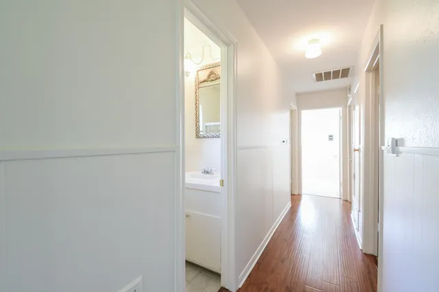 a bedroom with a bed and a night stand