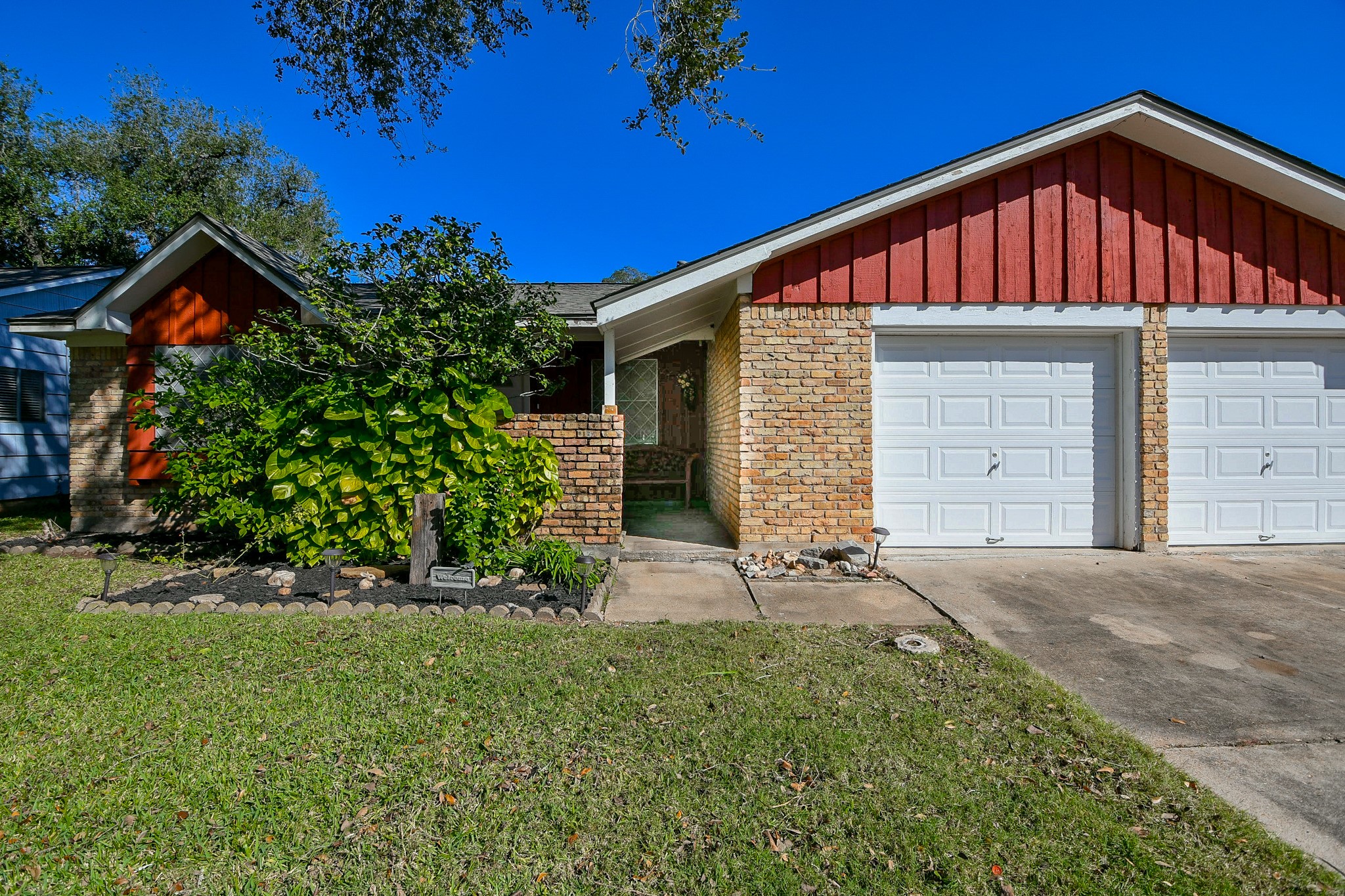 129 Cannon Street Clute, TX 77531 - Photo 3 of 28 a front view of a house with a yard and garage