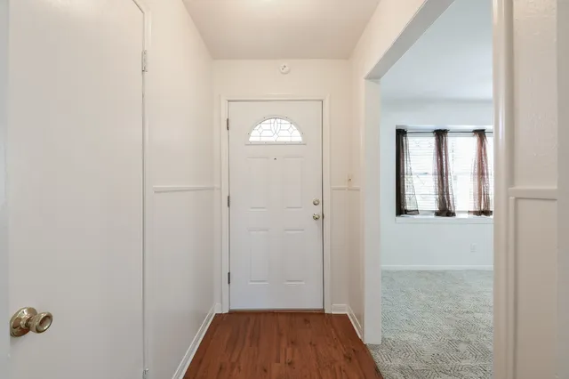 an empty room with windows and entrance