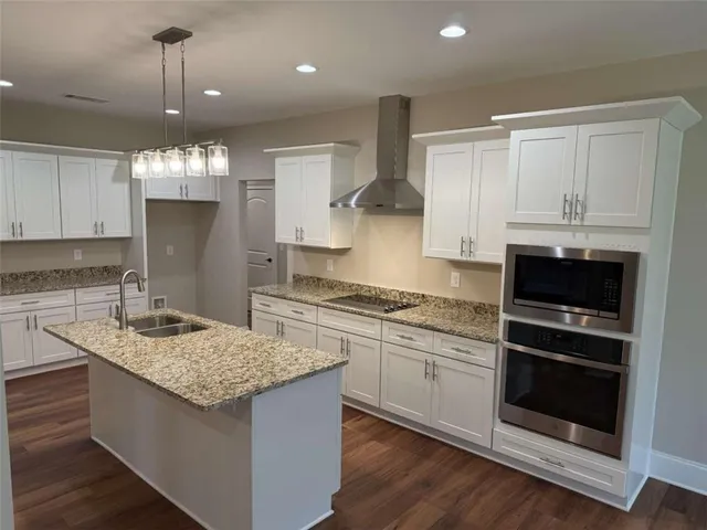 a kitchen with granite countertop white cabinets and a granite counter tops