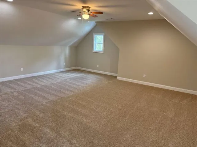 a white toilet sitting next to a sink and vanity