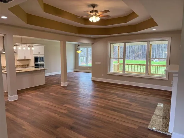 a view of empty room with wooden floor and fireplace