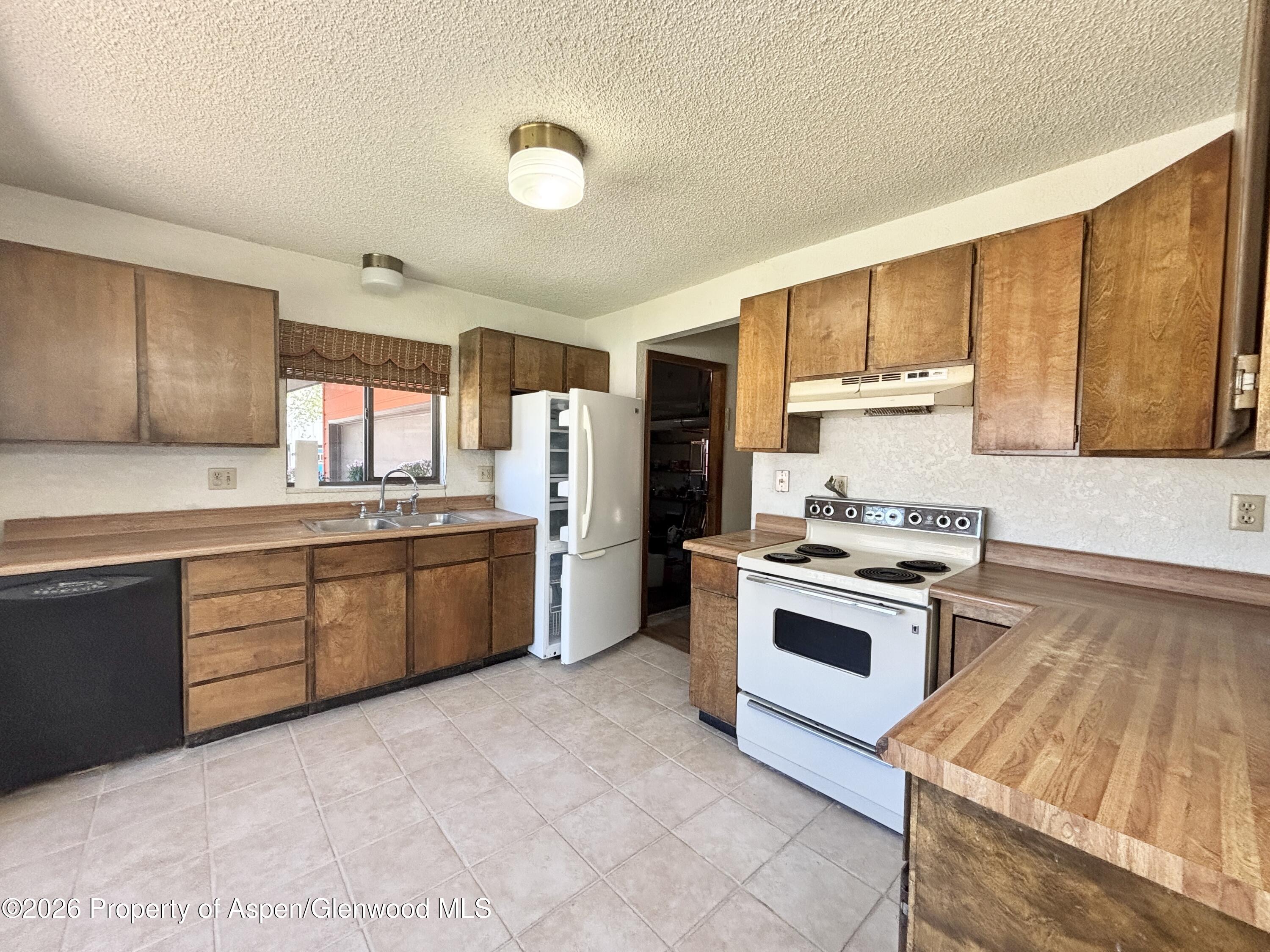 1623 West 7th Street Rifle, CO 81650 - Photo 4 of 21 a kitchen with a white cabinets and white appliances
