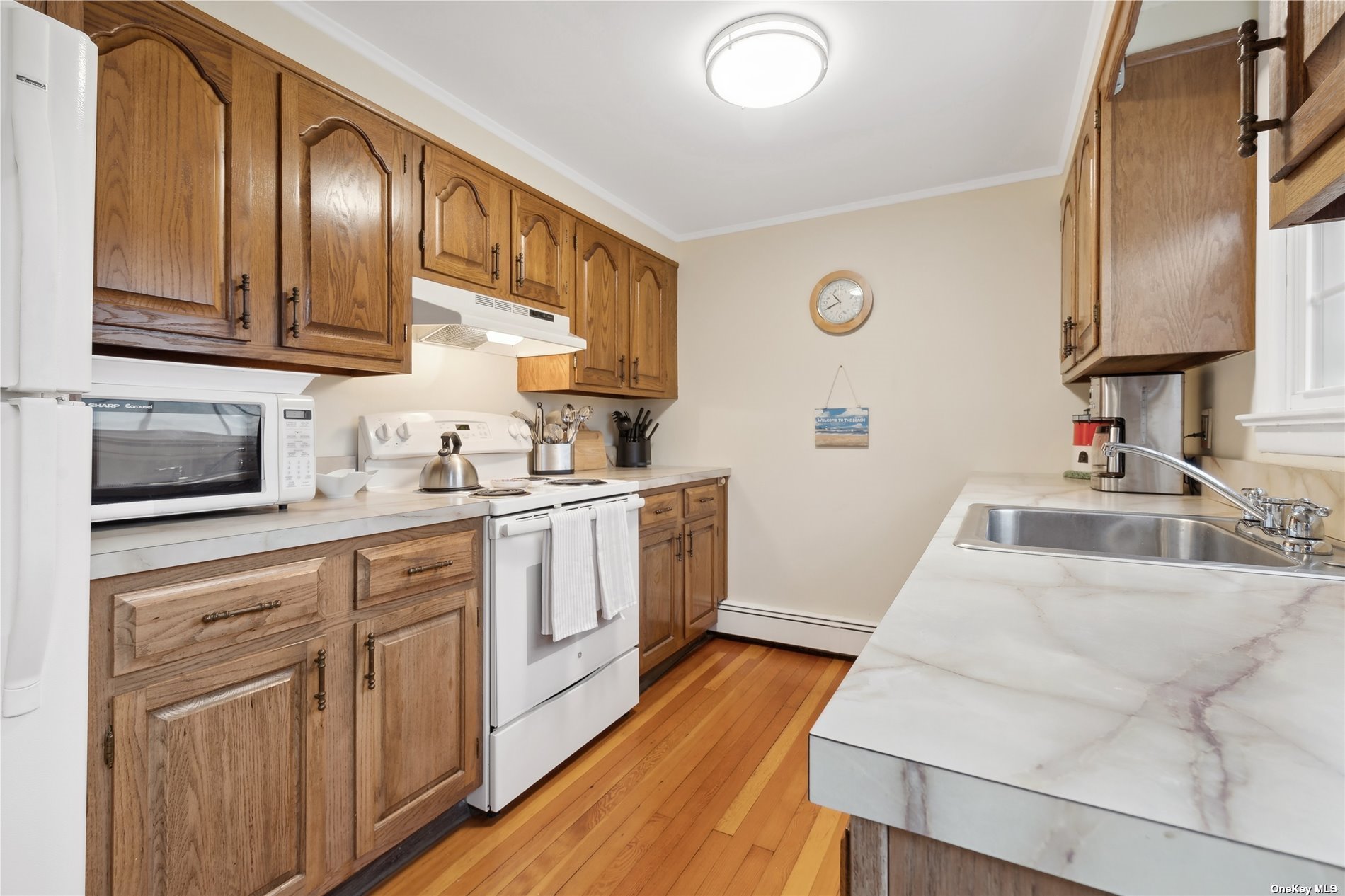220 Greenport, undefined 00000 - Photo 6 of 21 a kitchen with cabinets and wooden floor