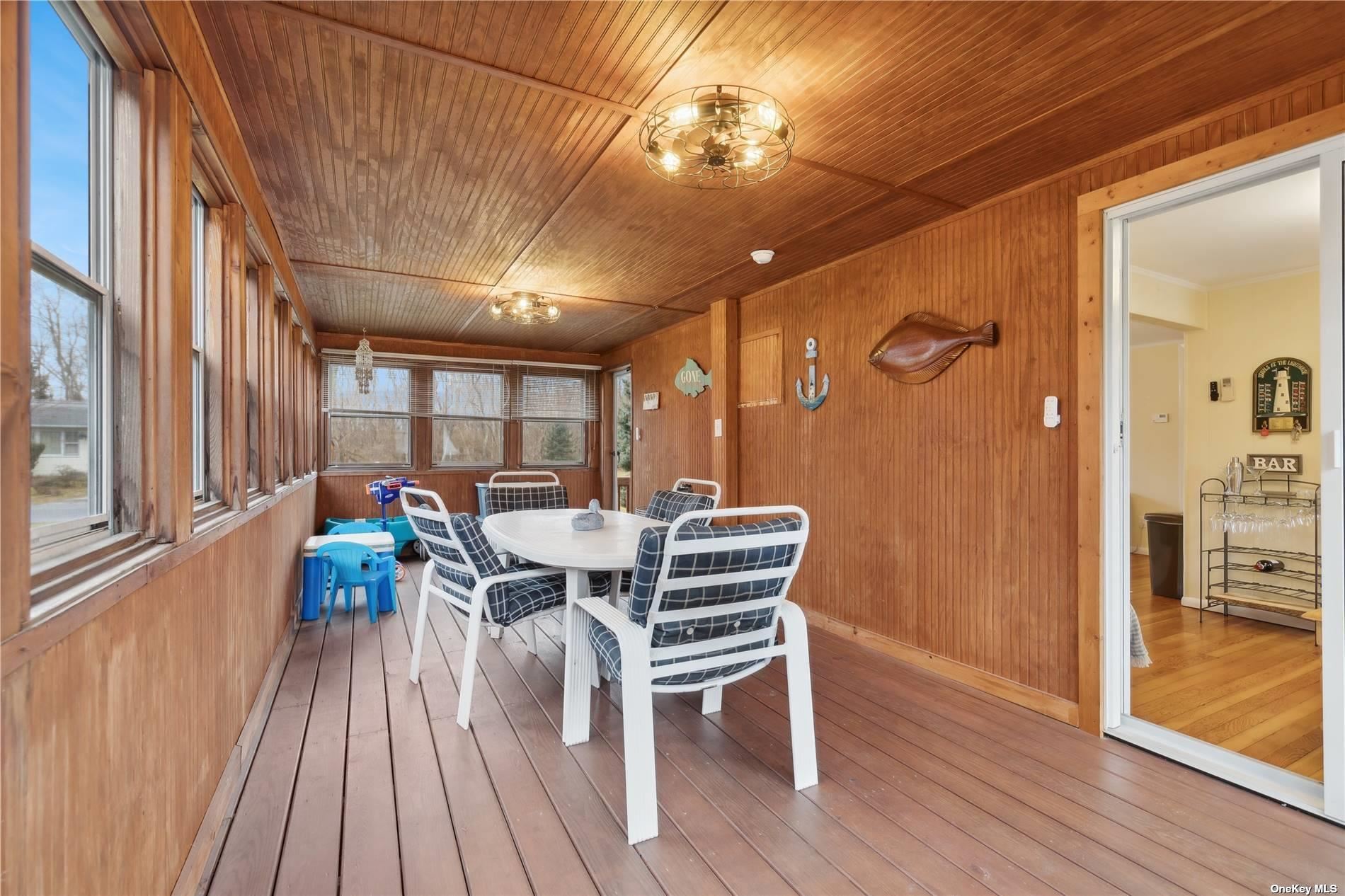 220 Greenport, undefined 00000 - Photo 9 of 21 a view of a dining room with furniture window and wooden floor