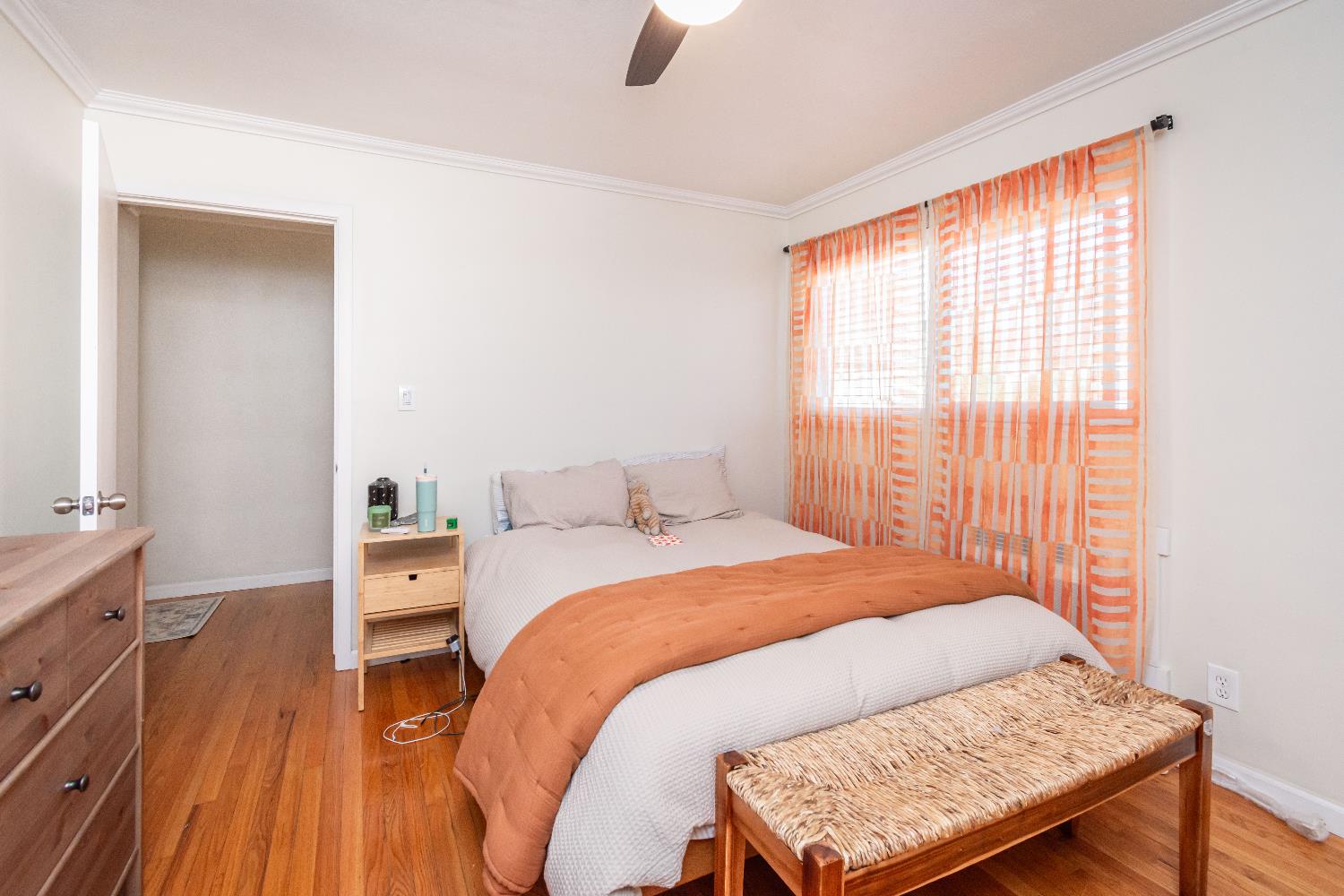 2811 F Street Sacramento, CA 95816 - Photo 11 of 22 a bedroom with a bed and wooden floor