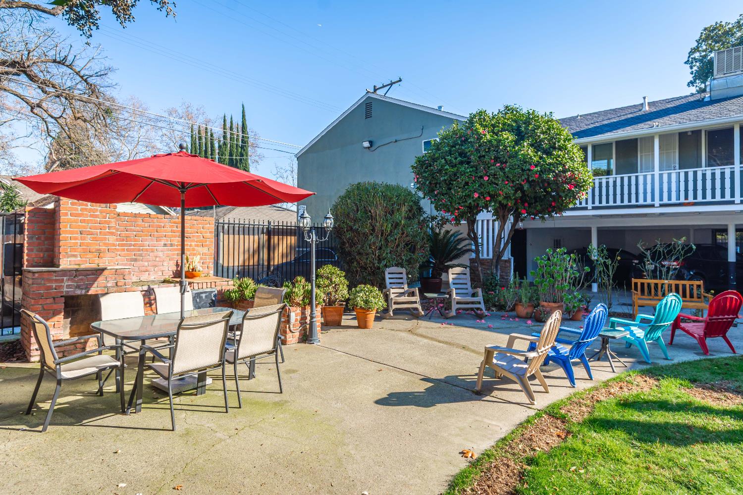 2811 F Street Sacramento, CA 95816 - Photo 14 of 22 a view of a patio with a table and chairs under an umbrella