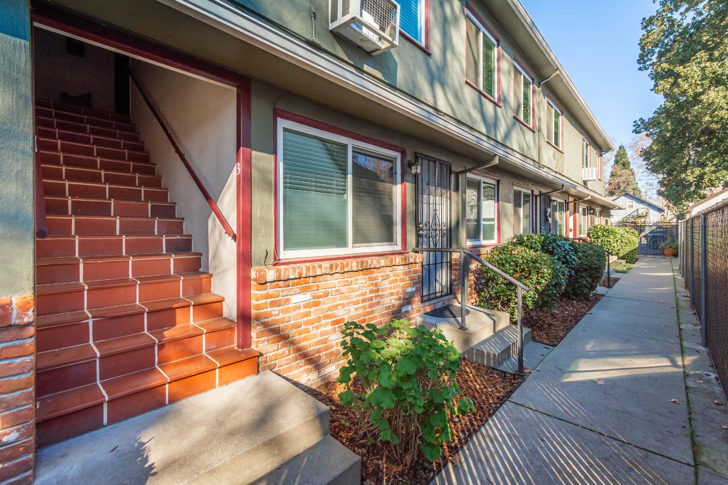 2811 F Street Sacramento, CA 95816 - Photo 16 of 22 a view of a house with a large window and flower plants