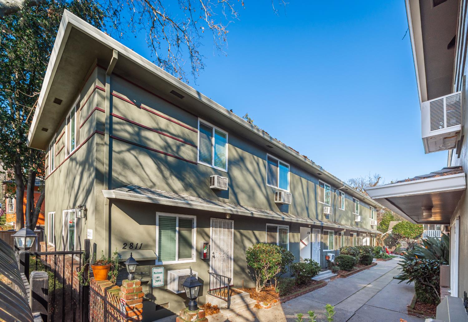 2811 F Street Sacramento, CA 95816 - Photo 4 of 22 a large building with a large window and potted plants