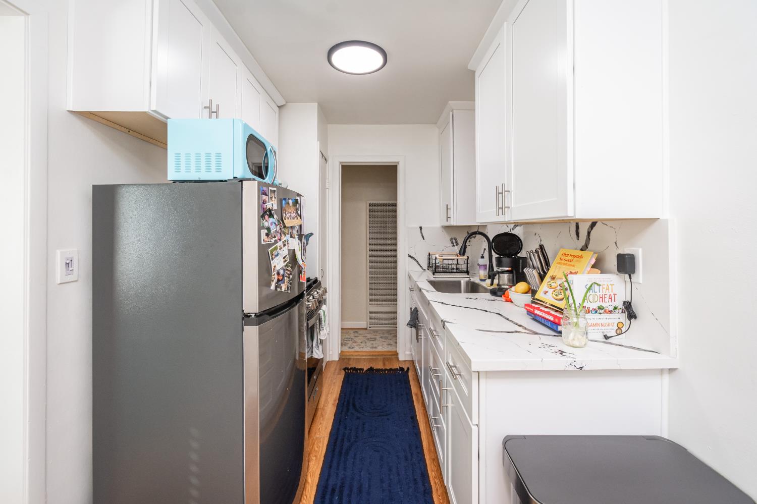 2811 F Street Sacramento, CA 95816 - Photo 9 of 22 a view of a kitchen with fridge and workspace