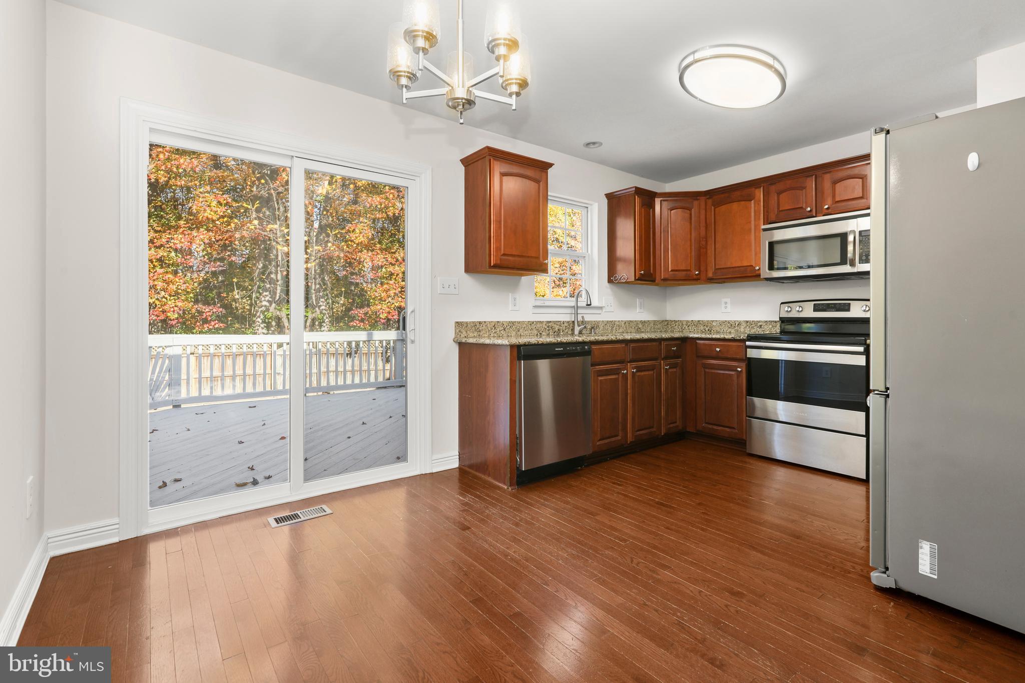 2826 Profitt Path Edgewood, MD 21040 - Photo 10 of 50 a large kitchen with stainless steel appliances granite countertop a stove sink and cabinets
