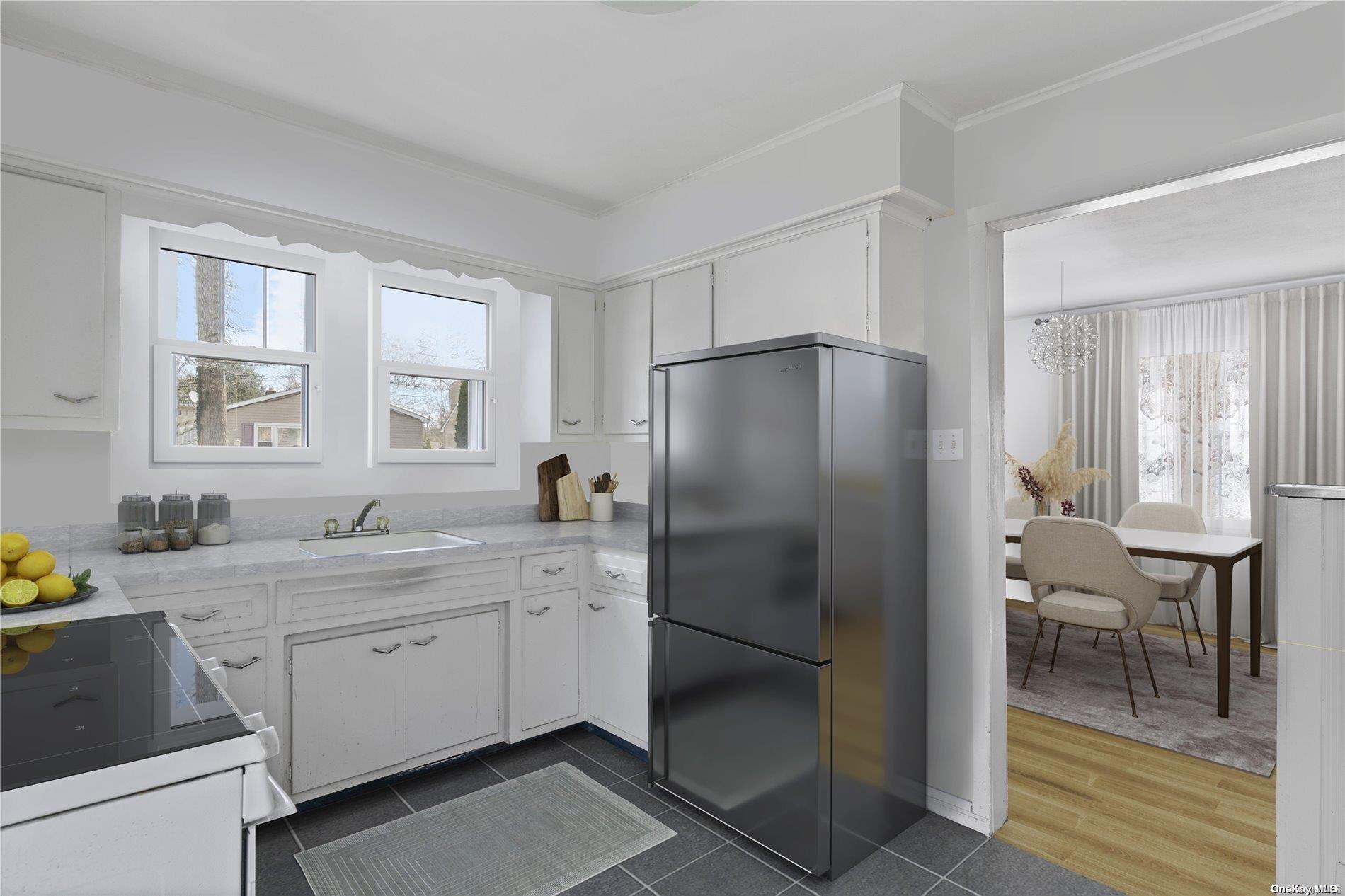 a kitchen with a refrigerator sink and cabinets