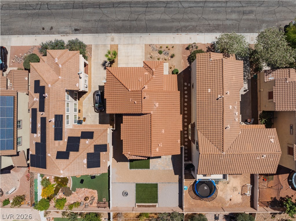 1328 Spice Ridge Court Henderson, NV 89012 - Photo 41 of 51 An aerial view captures the residential area, highlighting rooflines and outdoor spaces.