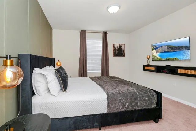a bedroom with bed and wooden floor
