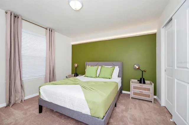 a bedroom with a bed and a window