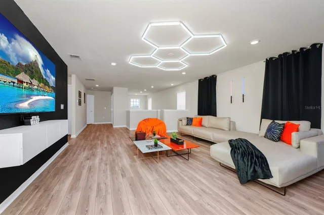 a living room with furniture and a flat screen tv