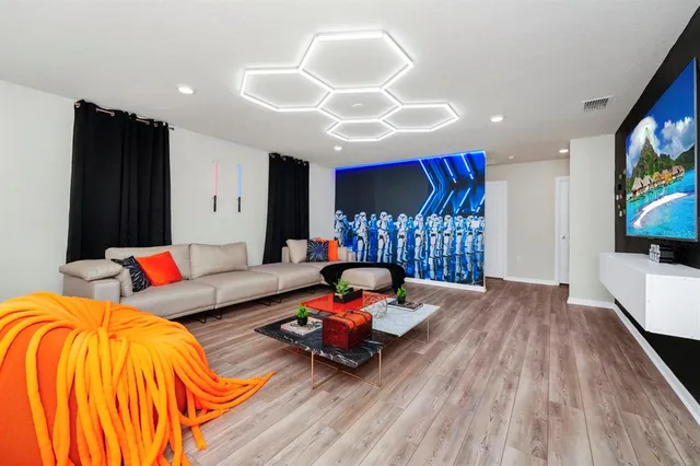 a living room with furniture and a flat screen tv