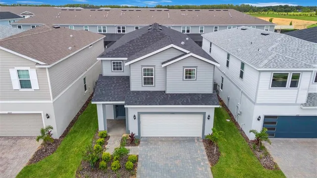 a aerial view of a house with a yard