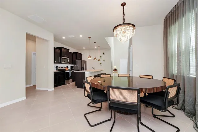 a view of a dining room with furniture and chandelier