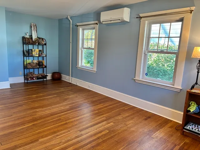 an empty room with wooden floor and closet