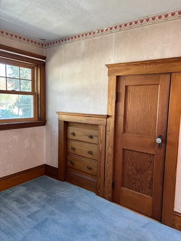 a view of walk in closet with wooden floor