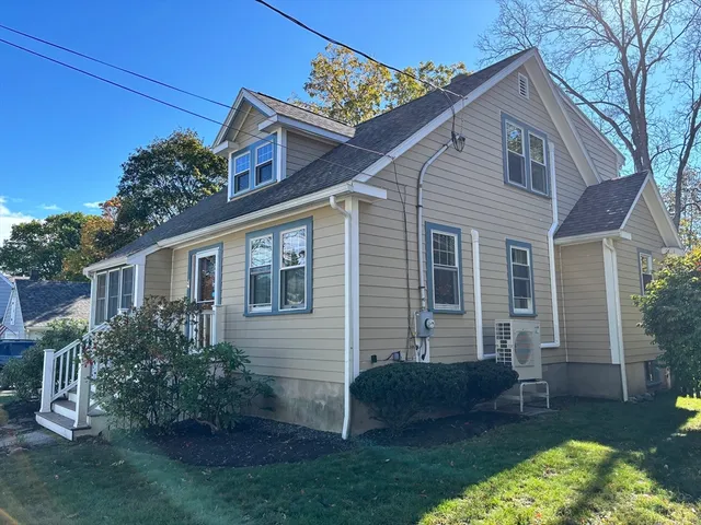 a view of a house with a yard and a garden