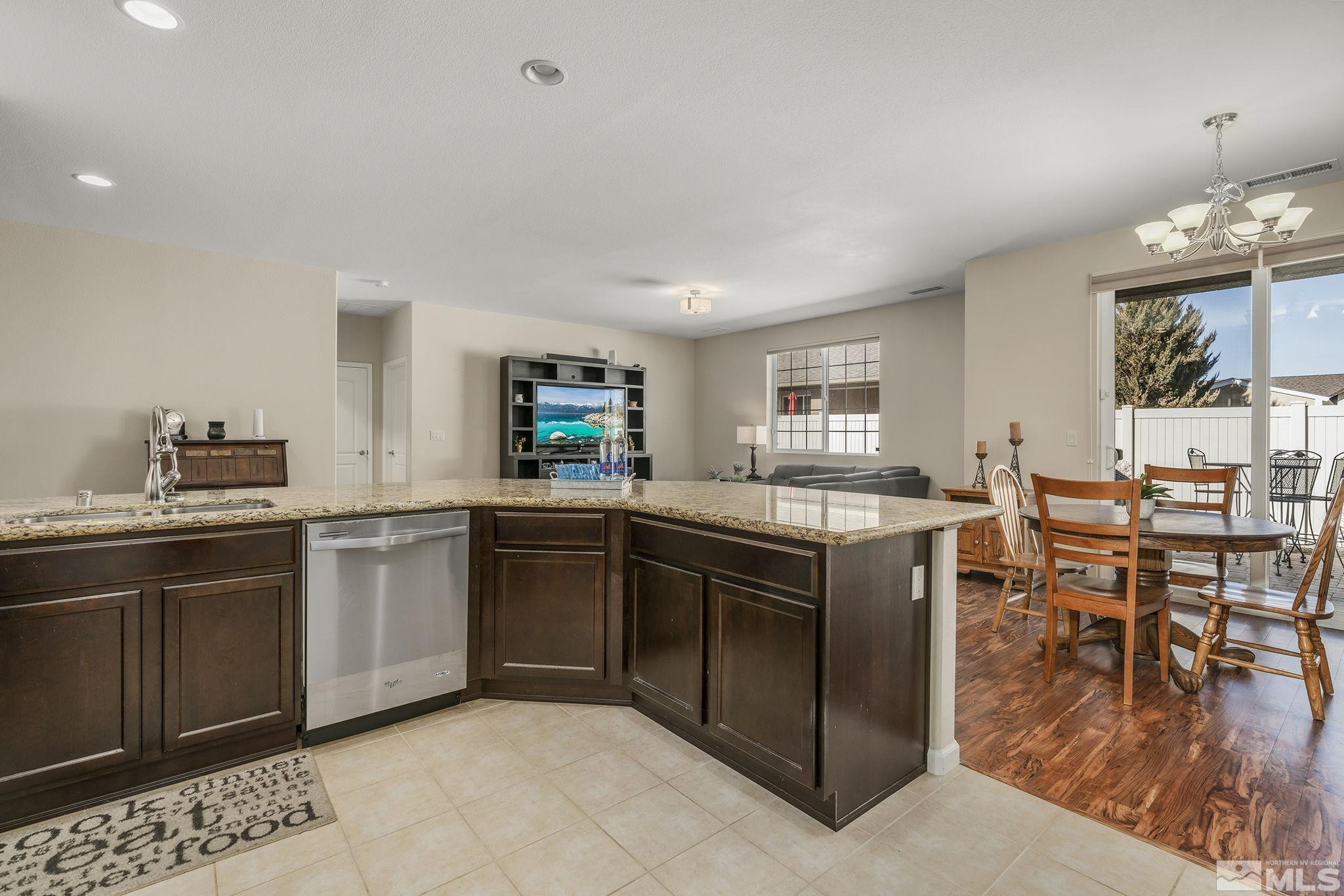 2249 Dominic Drive Reno, NV 89521 - Photo 12 of 22 a kitchen with stainless steel appliances granite countertop a table and chairs in it