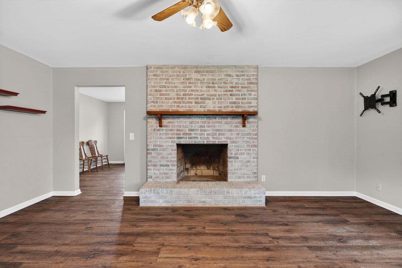 3259 Zion Church Road Broadway, VA 22815 - Photo 6 of 48 a living room with a fireplace and a wooden floor