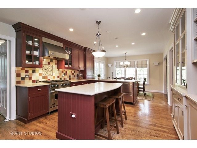 1039 Miami Road Wilmette, IL 60091 - Photo 9 of 25 a kitchen with stainless steel appliances kitchen island granite countertop a refrigerator a sink dishwasher and a dining table with wooden floor