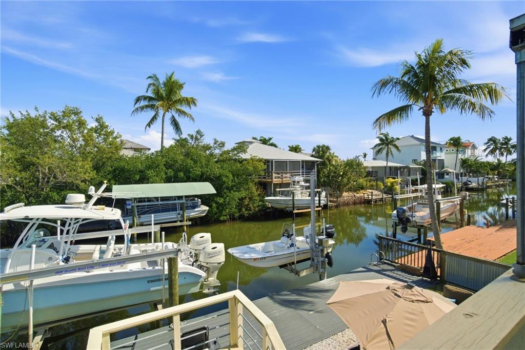 1286 Venetian Way Naples, FL 34110 - Photo 36 of 46 a view of a lake with house