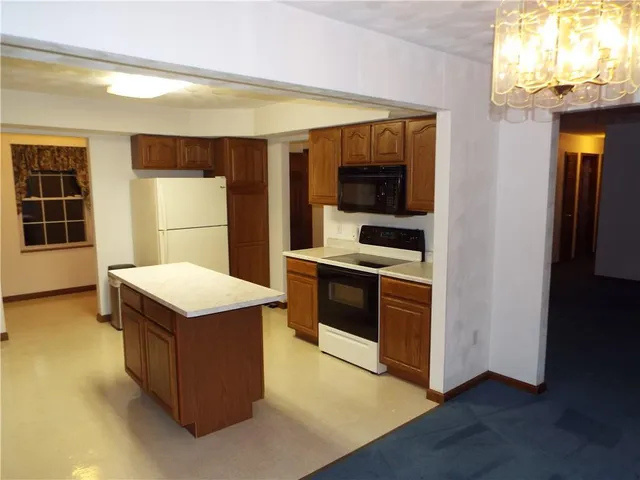 a kitchen with stainless steel appliances a stove microwave and refrigerator