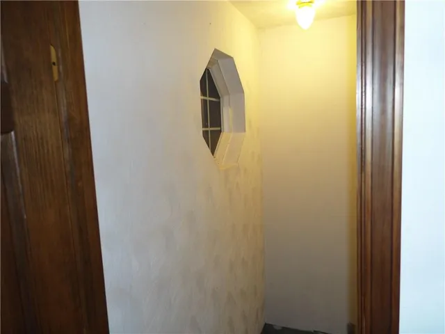 a view of a wooden chair and fire pit in the backyard